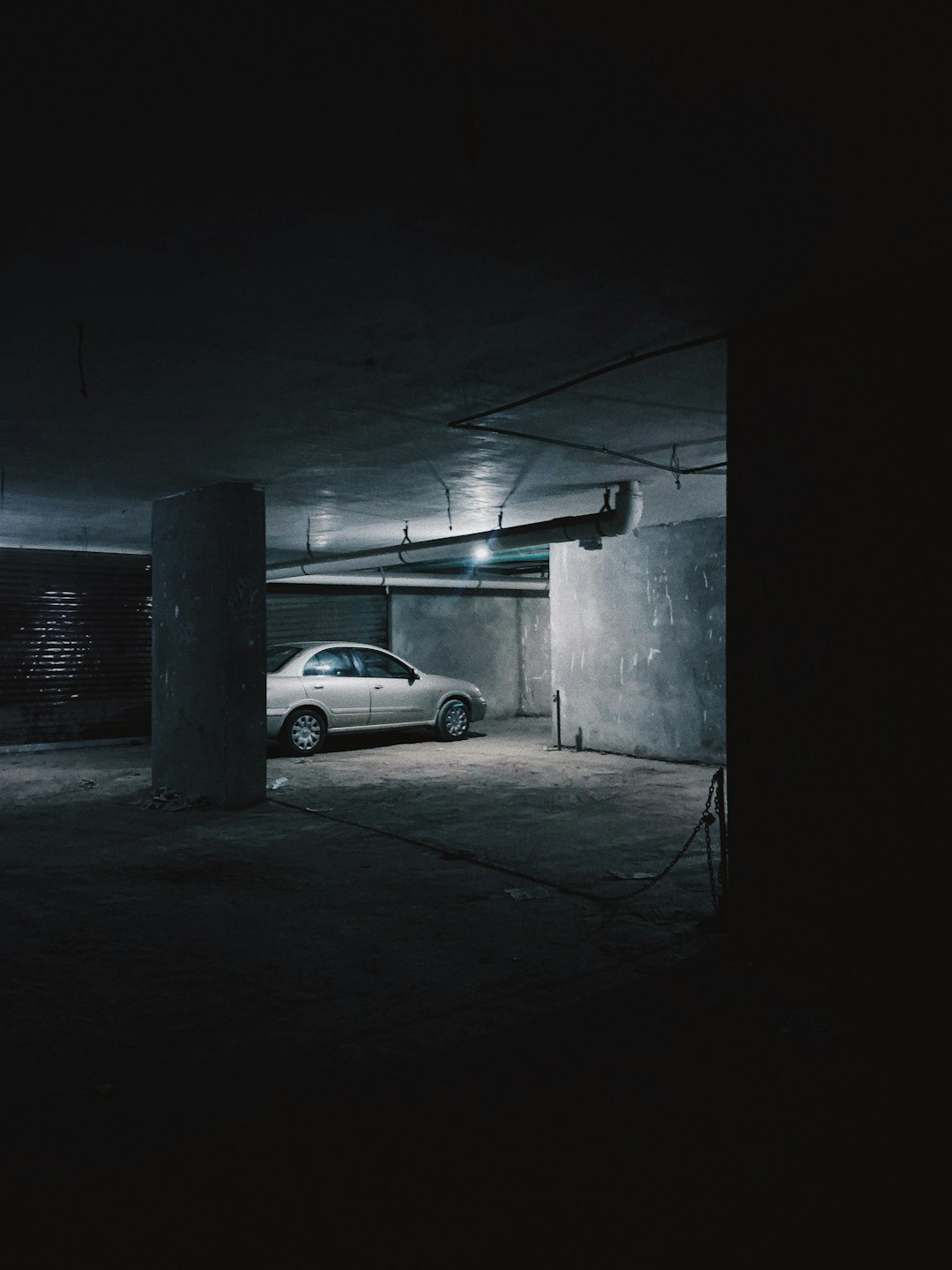 A collector car resting in a dark basement